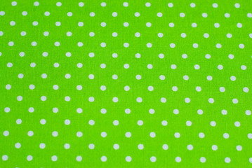 green polka dot fabrics as a sewing background