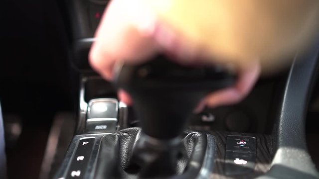 young girl switches the automatic transmission selector