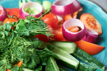 Blue plate with fresh vegetables. Beautiful serving of dishes. Restaurant menu