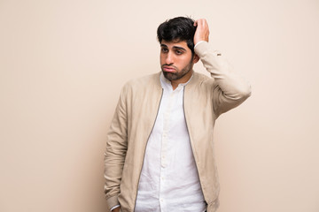 Fototapeta premium Young man over isolated wall with an expression of frustration and not understanding