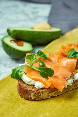 On a light gray background is a yellow plate with brockett. Beautiful serving of dishes. Restaurant menu