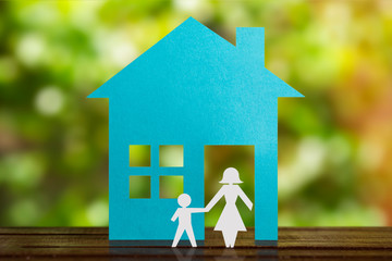 Single Mother With son in paper wit blue house. Divorced.