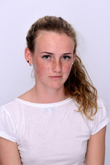 portrait of a young beautiful girl with blue eyes and freckles on a white background