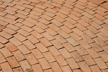 The red brick walkway is arranged in a row with a background patterned background.