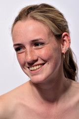 Obraz premium portrait of a young beautiful girl with blue eyes and freckles on a white background