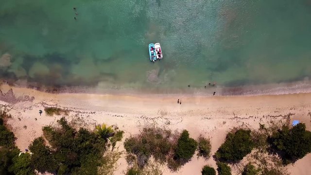 Beautiful Sun Bay beach with small fishing boats and people relaxing located on the tropical Caribbean island of Vieques Puerto Rico