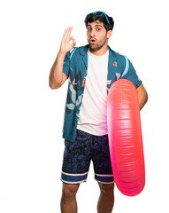 Man in trunks surprised and showing ok sign over isolated white background