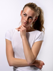 portrait of a young beautiful girl with blue eyes and freckles on a white background