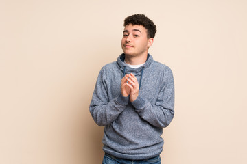 Young man over isolated wall scheming something