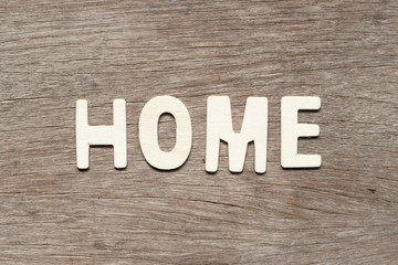 Alphabet letter in word home on wood background