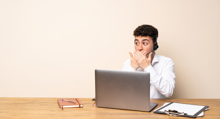 Telemarketer man covering mouth and looking to the side