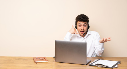Telemarketer man making phone gesture and doubting