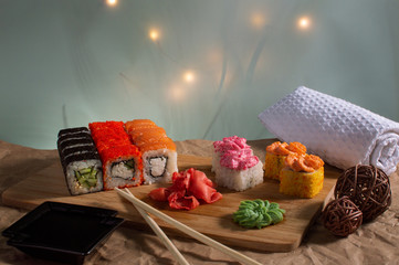 sushi in the sun on a wooden board with a beautiful background