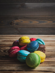 macaroons on wood table with cup and flowers