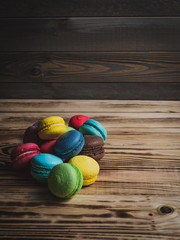 multicolored macaroon on a dark wooden table