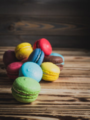 macaroons on wood table with cup and flowers