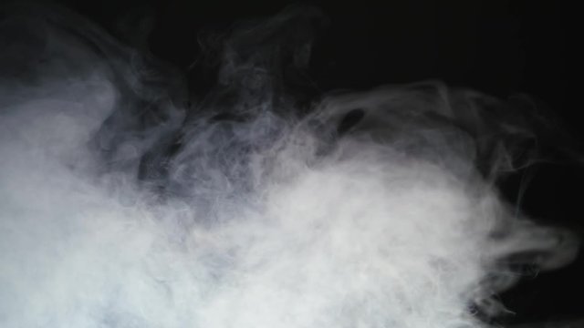 Smoke background. Abstract smoke cloud. Smoke in slow motion on black background. White smoke slowly floating through space against black background. Smoke effect. Fog effect. Smoke machine