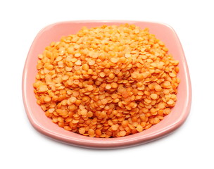 Red lentils with bowl isolated on white