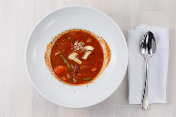 tomato soup with vegetables and microgreen top view