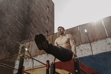 Young man practicing calisthenics.