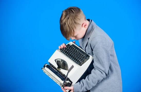 Retro and vintage. Yard sale. Retrospective study. Boy hold retro typewriter on blue background. What to do with this thing. Out of date. I need modern gadget instead this retro. Outdated gadget