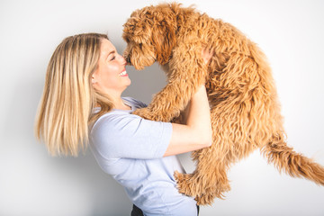 woman with his Golden Labradoodle dog isolated on white background