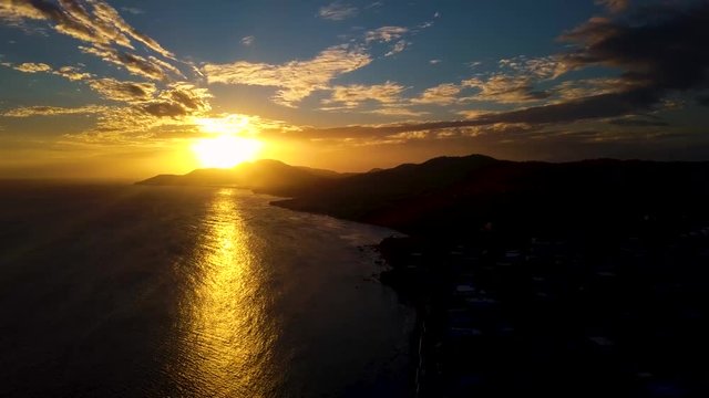 View of the bay of the small town of Esmeralda located in Vieques Puerto Rico during sunset and dusk with beautiful vivid colors among boats, islands, and coast.