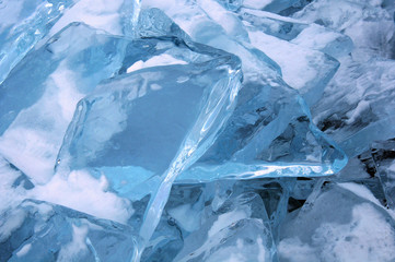 Sun rays are refracted by the transparent ice of Lake Baikal. crystal clear ice fragments —...