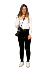 Full body of Young photographer woman surprised and shocked while looking right