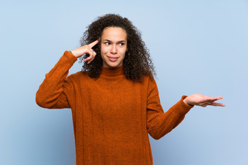 Dominican woman with curly hair making the gesture of madness putting finger on the head