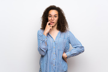 Dominican woman with striped shirt having doubts while looking up