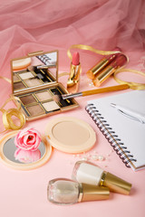 Woman's cosmetics on romantic pink lacy tulle background. Women's morning secrets. Lipstick,...
