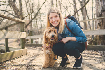 Happy Labradoodle Dog and woman outside at the park