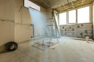 Renovation concept - room during restoration set the tube on the ceiling for air conditioner