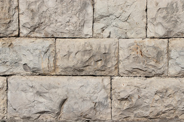 Stone natural wall in blocks. The texture of the stone block-lined wall of natural yellowing stone.