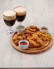 Beer and beer plate on wooden background.