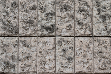 Natural stone wall vertical blocks. The texture of the stone lined with blocks of natural limestone stone.