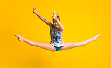 Girl doing rhythmic gymnastics jumping