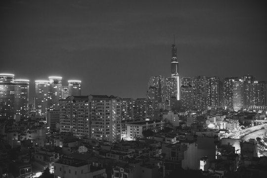 Fototapeta Ho Chi Minh City, Vietnam view at night on a new modern buildings and hotels and Financial Tower and skyscrapers background black and white