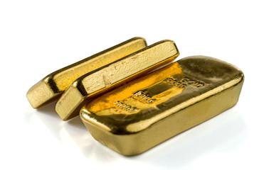 Three cast gold bars, the typical form of bullion gold bullion. Isolated on a white background....