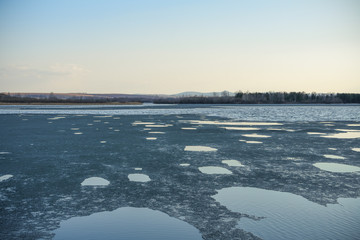 winter landscape with frozen lake and blue sky