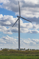 Wind turbine in a field under a cloudy sky. Province North Brabant, Netherlands