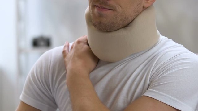 Man wearing foam cervical collar suffering from pain in shoulder and neck