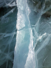 Sun rays are refracted by the transparent ice of Lake Baikal. cracks at different depths create a bizarre web