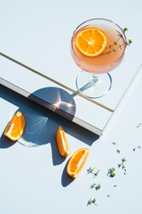 Grapefruit and thyme cocktails, refreshing drinks with ice on a light blue background. Summer...