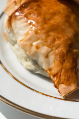 Spanakopita in the shape of a triangle on a plate