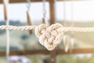 White rope in heart shape knot on background. Love concept.