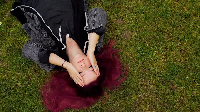 emo girl with purple hair pondering about life on the floor