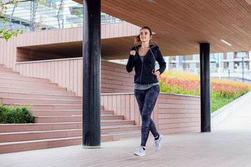 Young woman running outdoor in urban enviroment