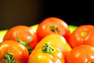 Beautiful red tomatoes in close up view on table